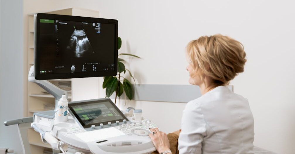 A healthcare professional conducting an ultrasound scan in a clinic setting.